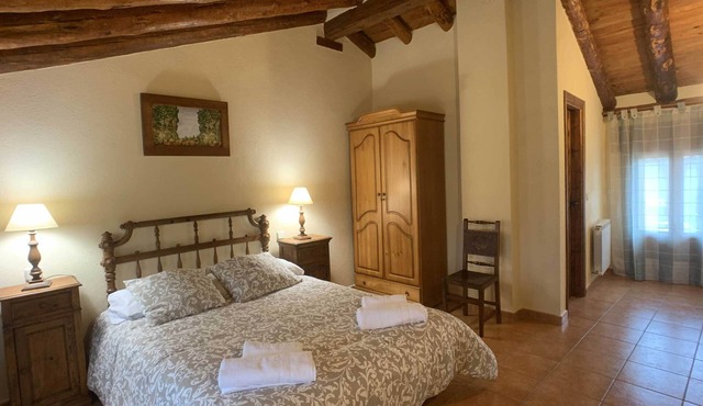Two spacious mountain houses built with traditional materials.